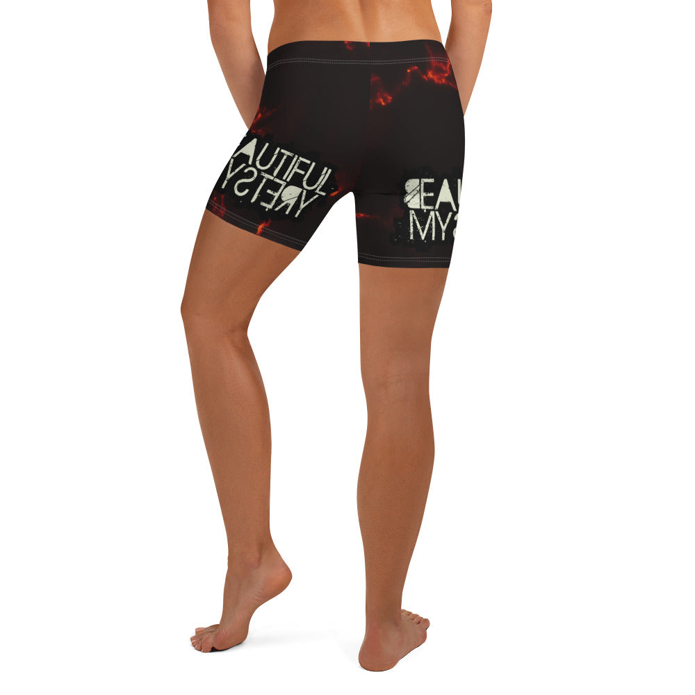 Product A woman stands confidently in shorts adorned with vibrant flame patterns, showcasing a bold and stylish summer look.