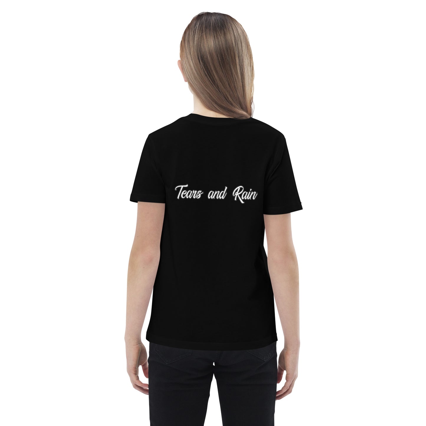 A girl in a t-shirt reading "my family is the greatest gift," smiling and standing in a bright outdoor setting.