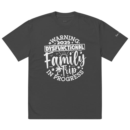A t-shirt displaying the text "Warning: This is a Family in Progress" in bold letters on a light background.